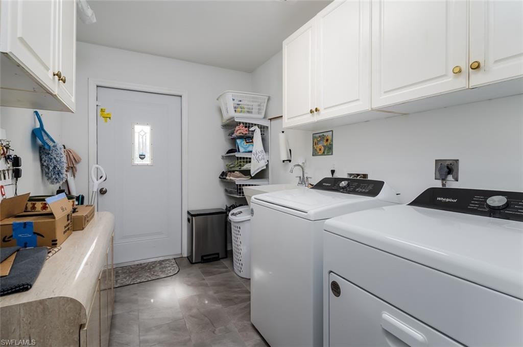 Laundry room featuring cabinet space and independent washer and dryer