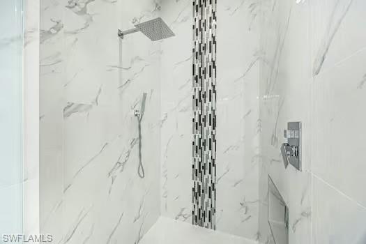 Bathroom featuring a marble finish shower
