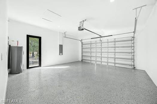 Garage featuring water heater and electric panel