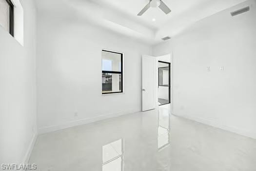 Unfurnished room with concrete floors and a ceiling fan