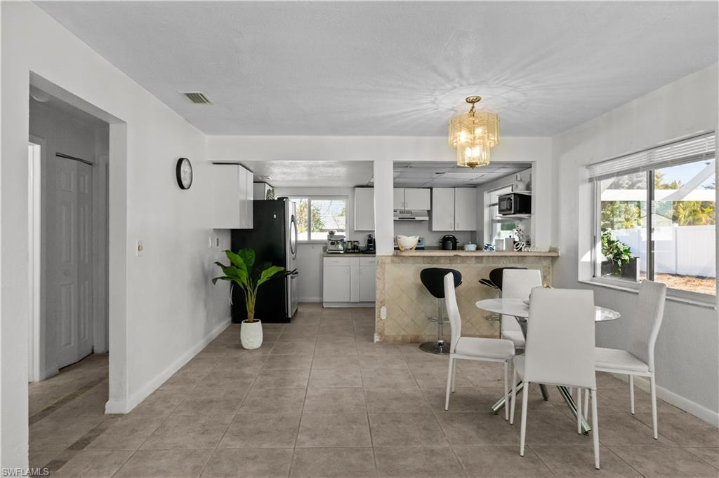 Dining room featuring suspended lighting and light tile patterned floors