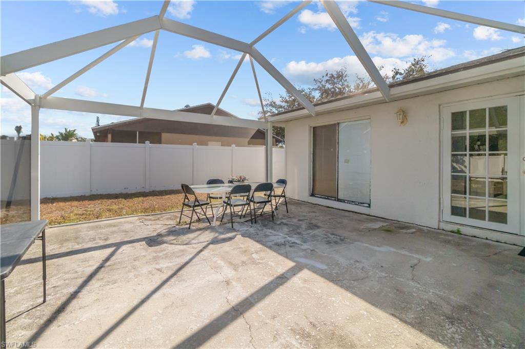 View of patio / terrace featuring outdoor dining space, a sunroom, and a lanai