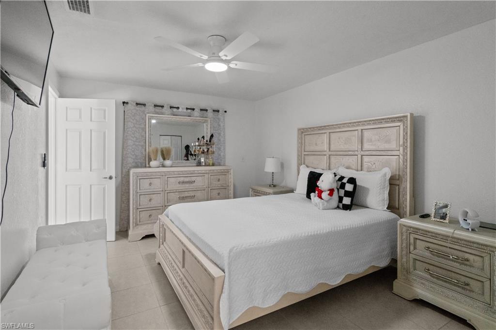 Bedroom featuring light tile patterned flooring and a ceiling fan