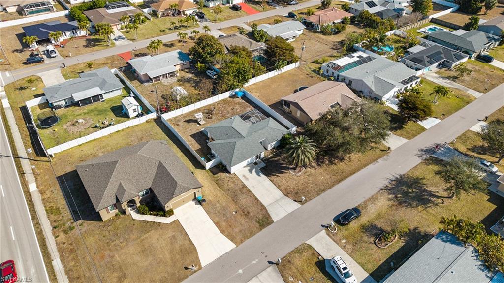 Aerial view of property's location with nearby suburban area