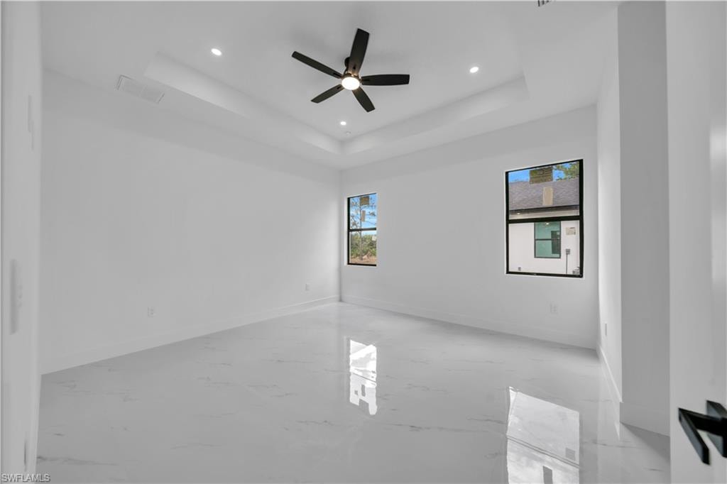Spare room with a ceiling fan, recessed lighting, and finished concrete floors