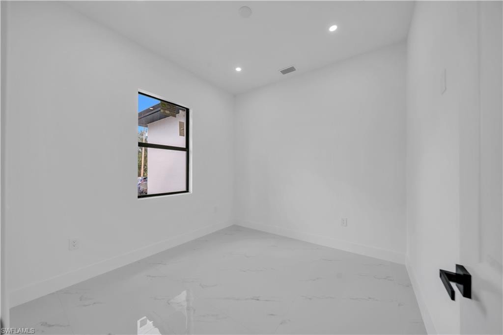 Spare room with recessed lighting and light marble finish flooring