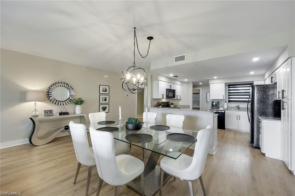 Dining room featuring light wood-style floors and suspended lighting