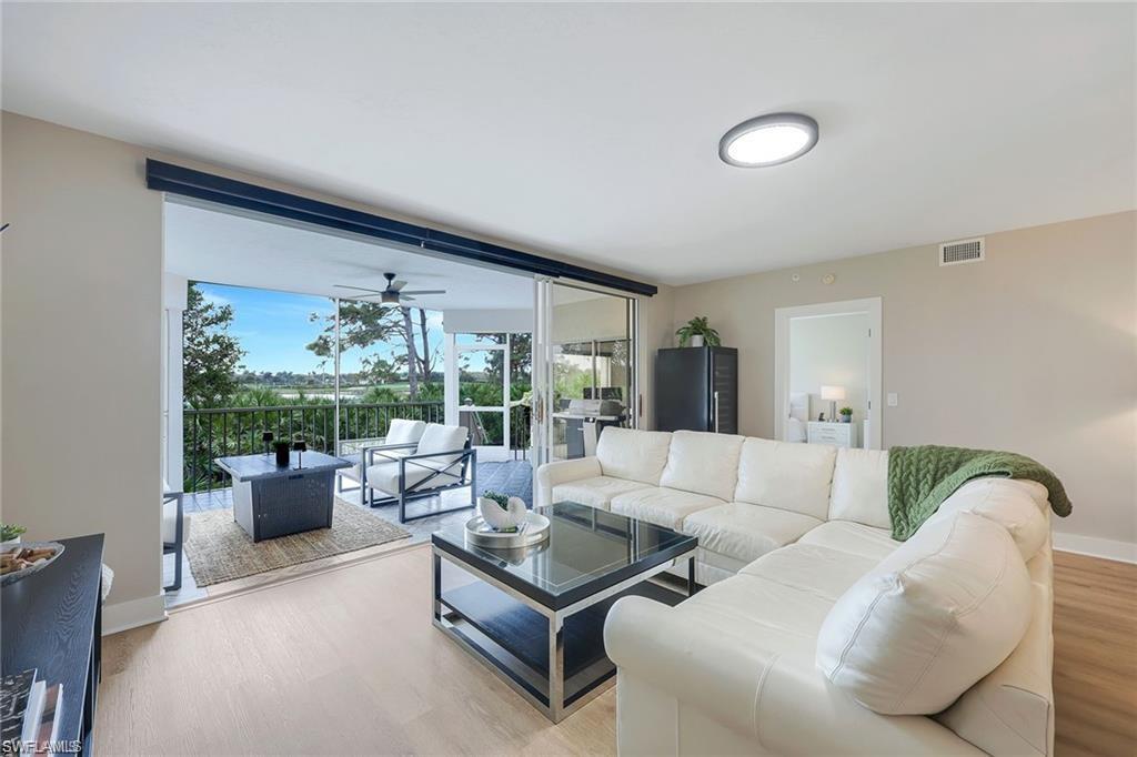 Living room featuring wood finished floors and a ceiling fan
