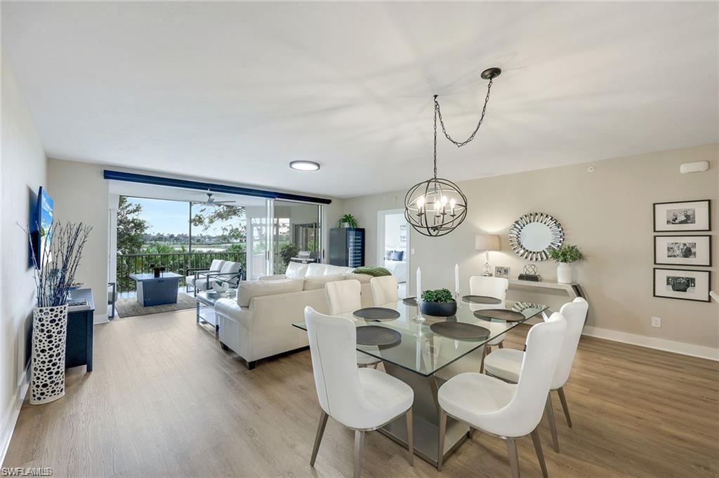 Dining space featuring light wood-style flooring, healthy amount of natural light, and suspended lighting