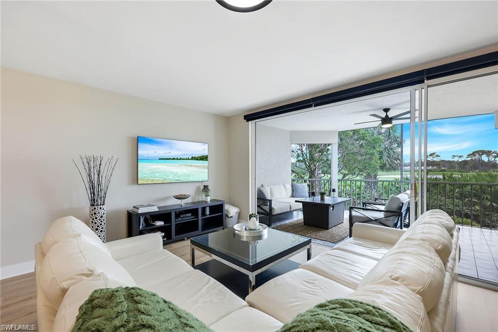 Living area with wood finished floors and ceiling fan
