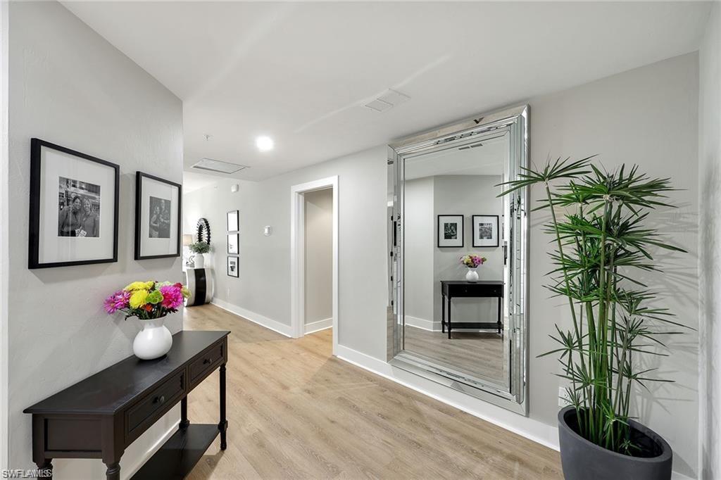 Corridor featuring light wood finished floors and baseboards