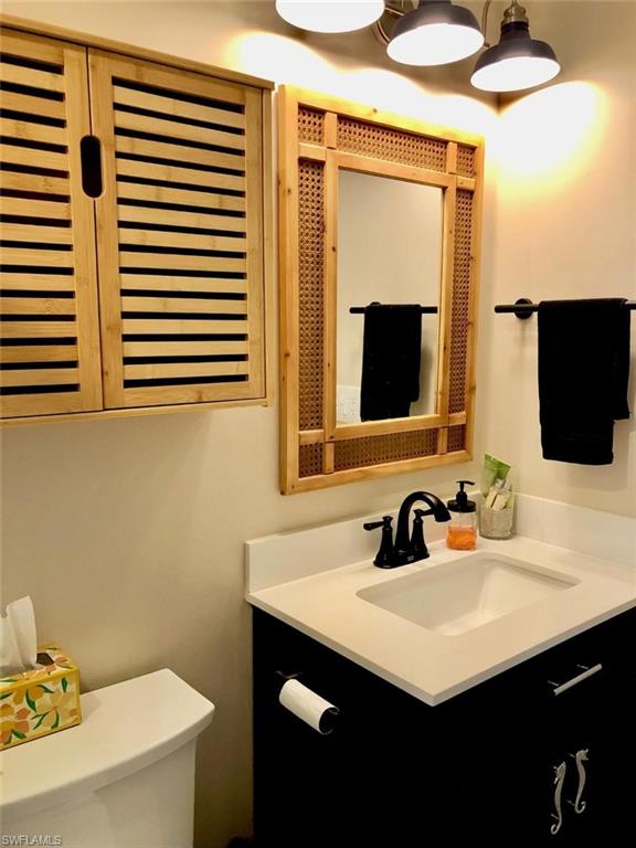 Half bath featuring vanity and toilet