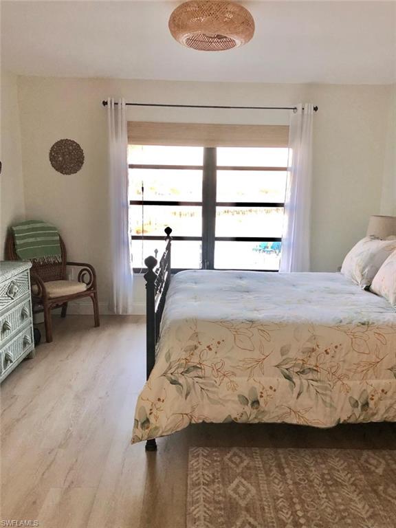 Bedroom with light wood-type flooring and baseboards