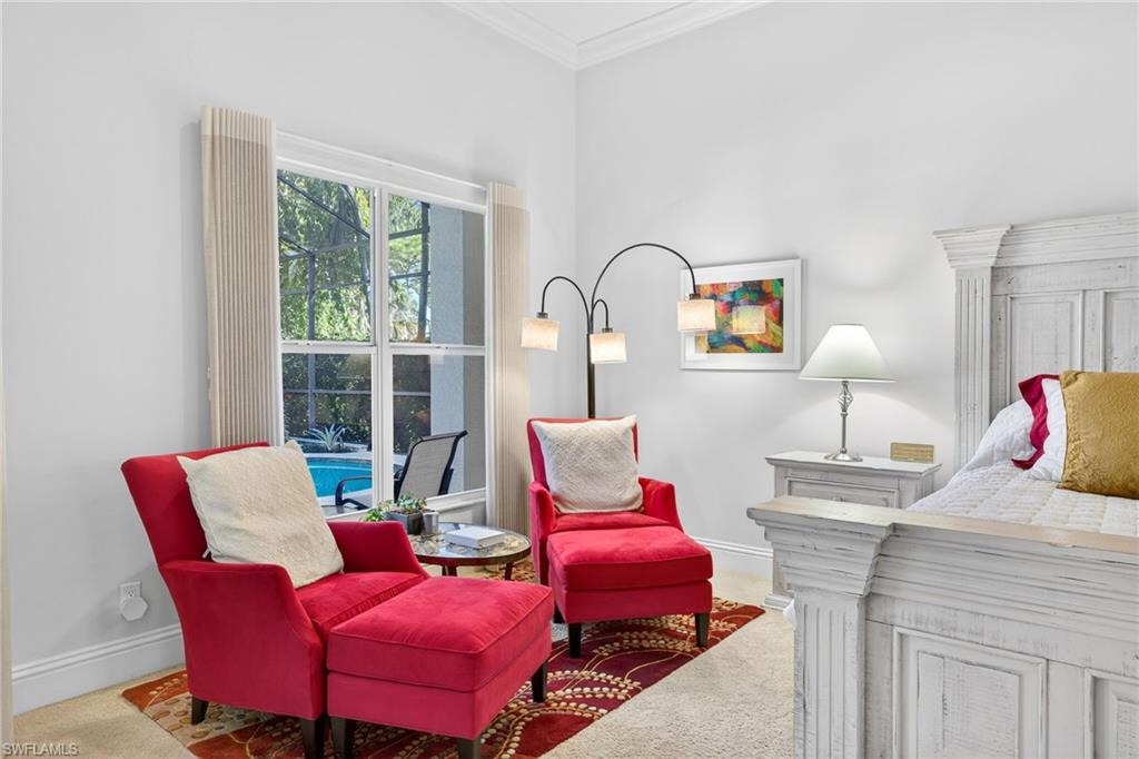 Sitting room with crown molding and carpet