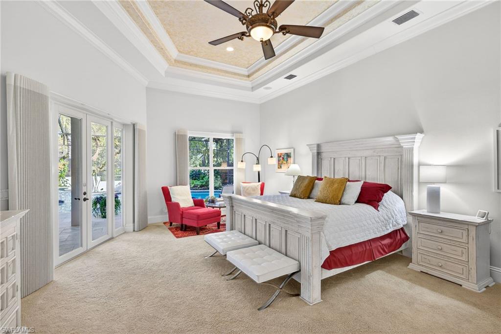 Bedroom featuring light colored carpet, crown molding, french doors, access to exterior, and ceiling fan