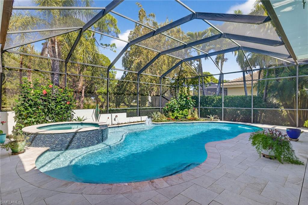 Combined pool / hot tub with a patio, glass enclosure, and a sunroom