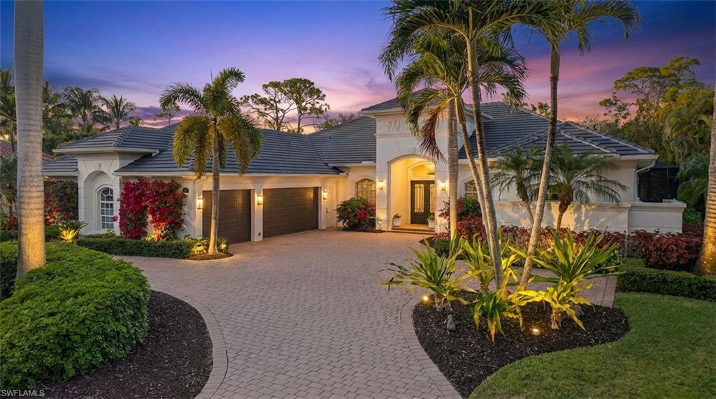 View of front of house featuring a tile roof, decorative driveway, an attached garage, and stucco siding
