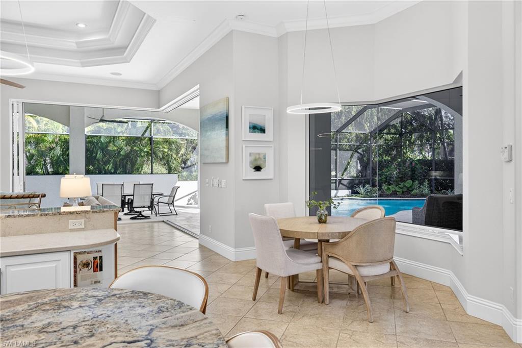 Dining space featuring a sunroom, crown molding, healthy amount of natural light, and light tile patterned floors