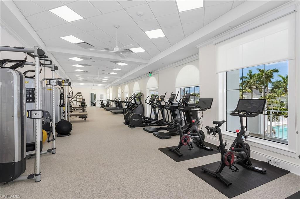 Exercise room featuring a drop ceiling and ceiling fan