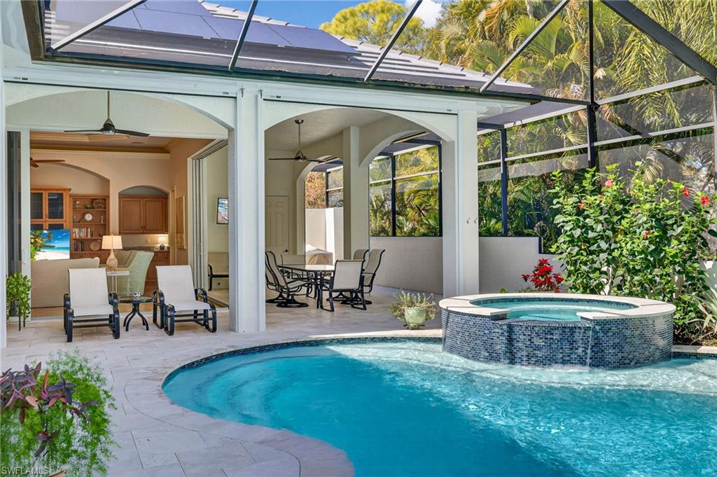 Relaxing pool / spa featuring outdoor dining space, a sunroom, a patio, and a lanai