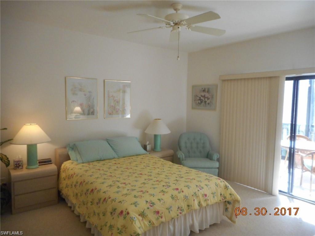 Carpeted bedroom featuring access to outside and a ceiling fan