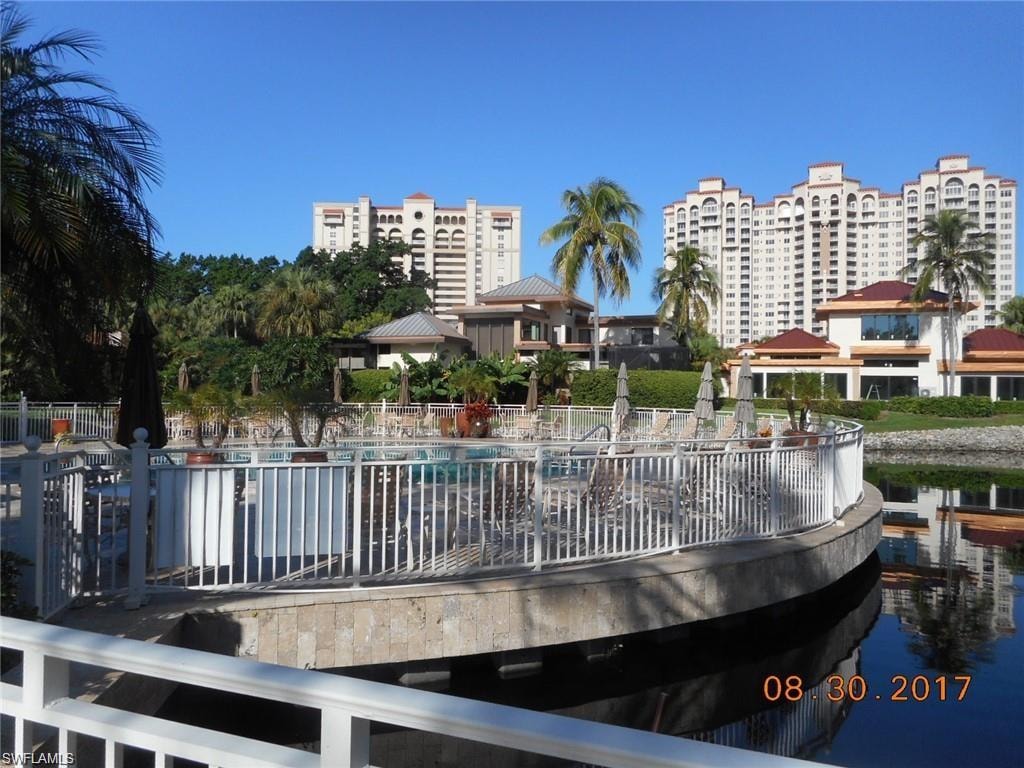 View of community with a water view and a swimming pool