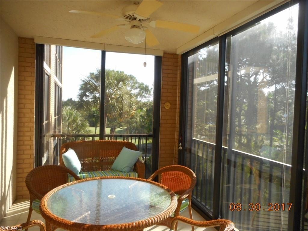 Sunroom / solarium with brick wall