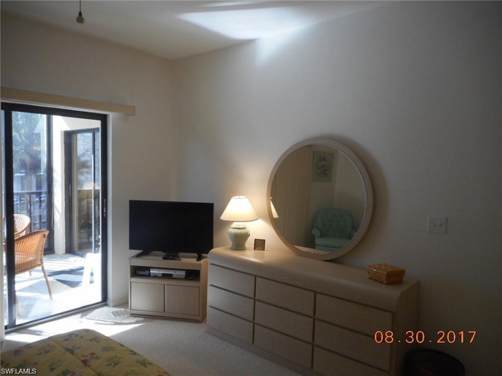 Bedroom featuring access to outside and light carpet
