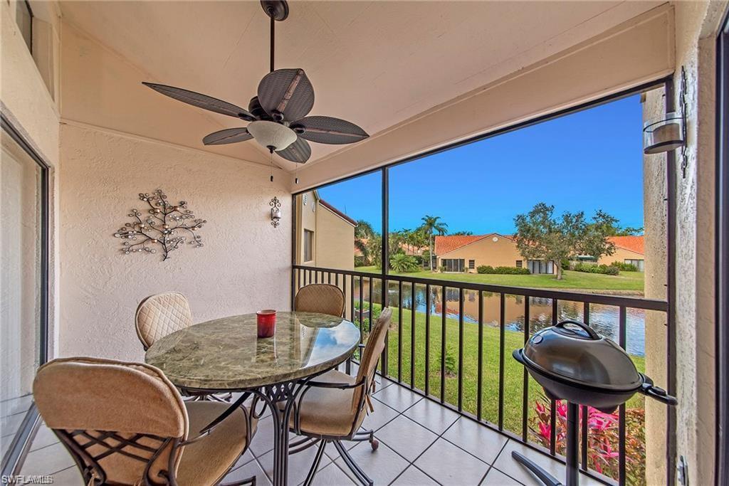 Sunroom / solarium with a balcony, outdoor dining area, ceiling fan, a residential view, and lofted ceiling