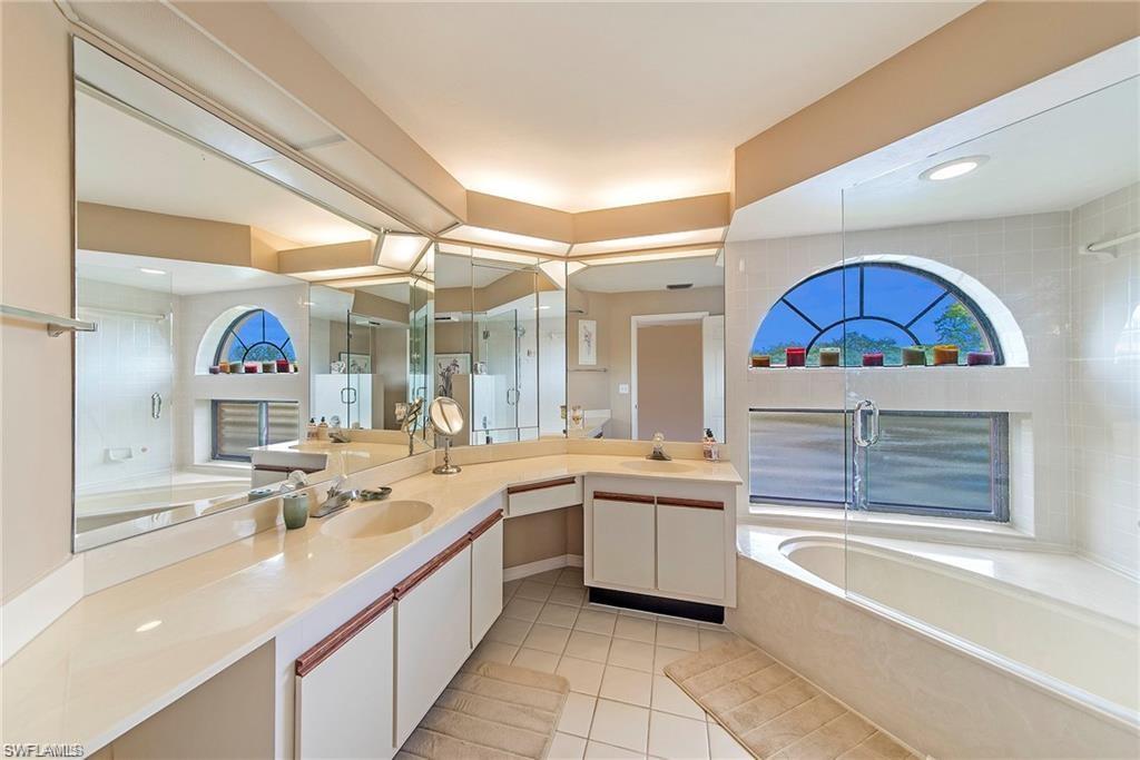 Bathroom with double vanity, light tile patterned floors, and recessed lighting