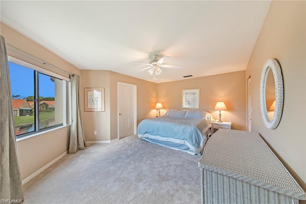 Carpeted bedroom with baseboards and a ceiling fan