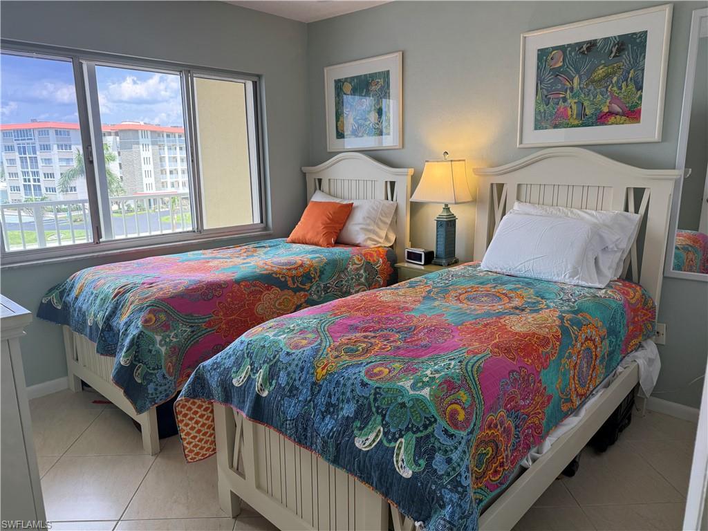 Bedroom with baseboards and light tile patterned floors