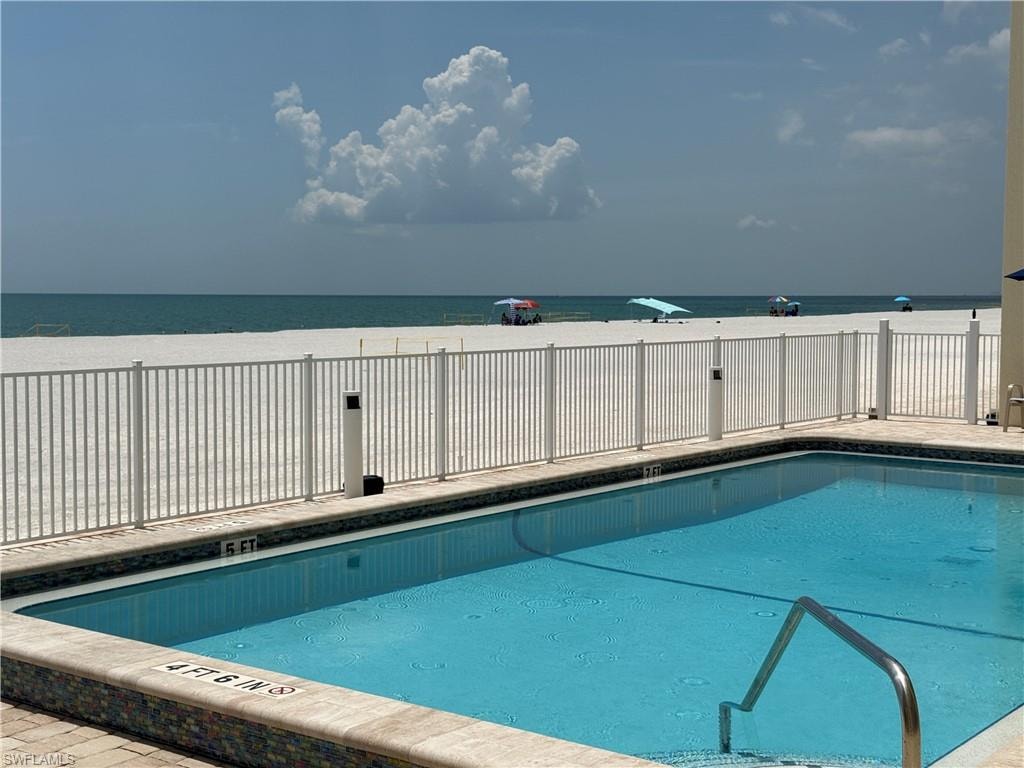 Community pool featuring a water view