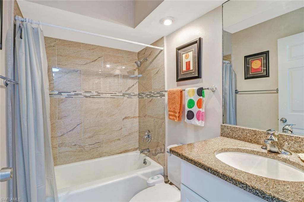 Bathroom featuring shower / bathtub combination with curtain and vanity