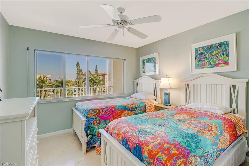 Bedroom with a ceiling fan and light tile patterned flooring
