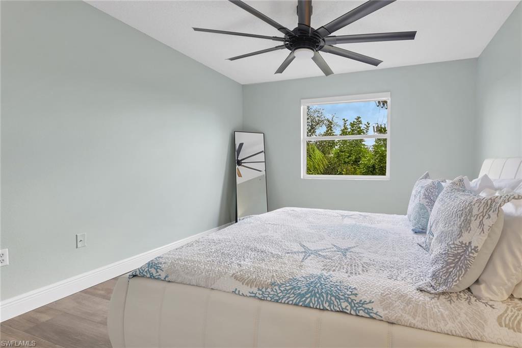 Bedroom featuring wood finished floors and a ceiling fan