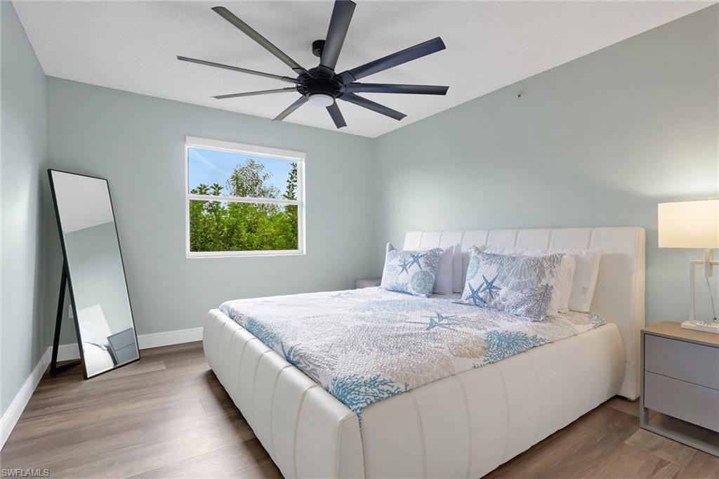 Bedroom featuring wood finished floors and ceiling fan