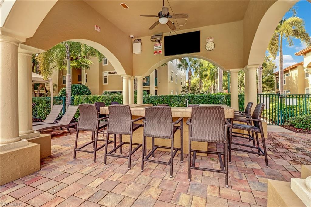 View of patio / terrace with ceiling fan and an outdoor bar