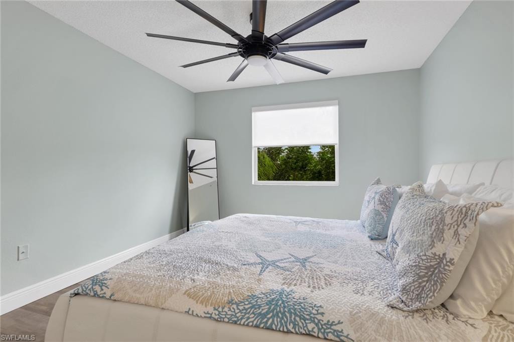 Bedroom with wood finished floors and a ceiling fan