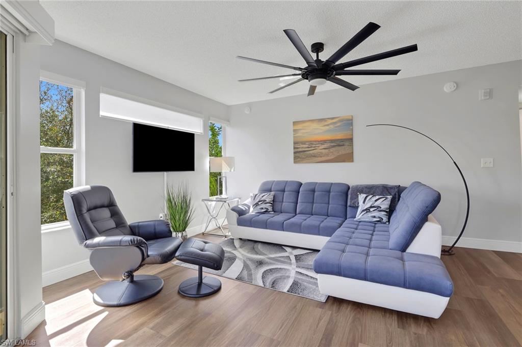 Living area featuring wood finished floors and a ceiling fan