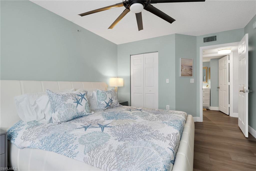 Bedroom featuring a closet, dark wood finished floors, and ceiling fan
