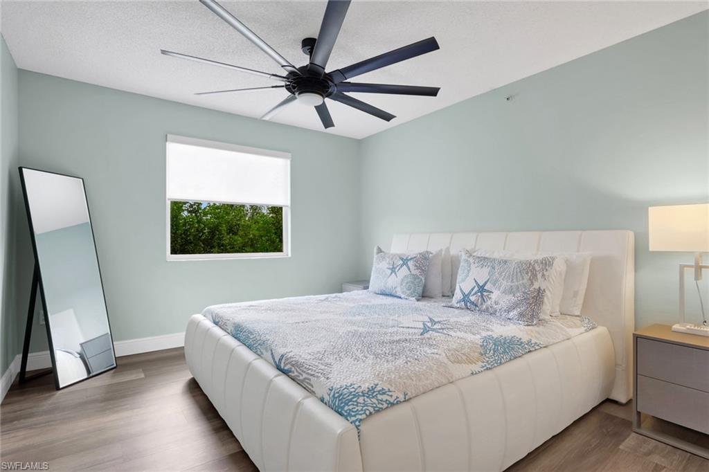 Bedroom with wood finished floors and a ceiling fan