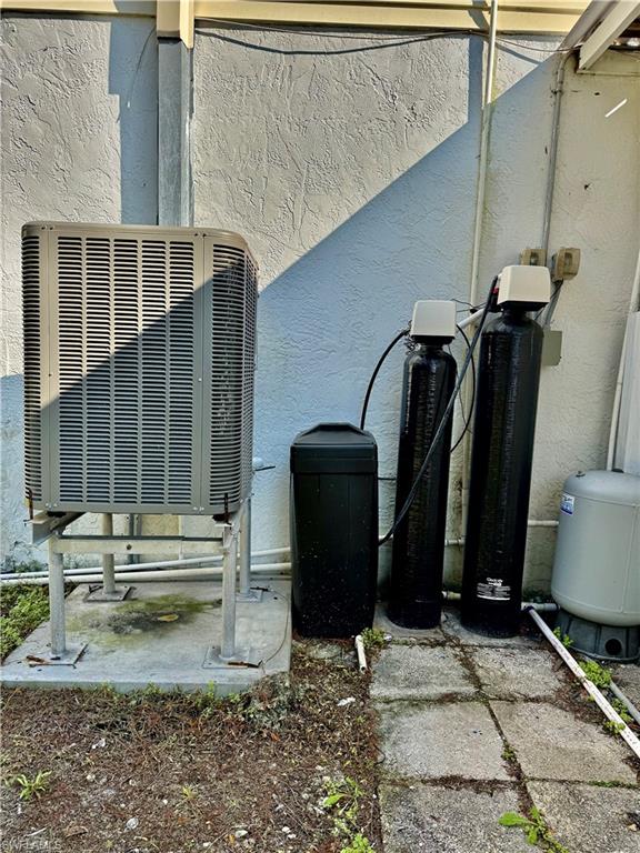 Exterior view of a water softener and stucco siding