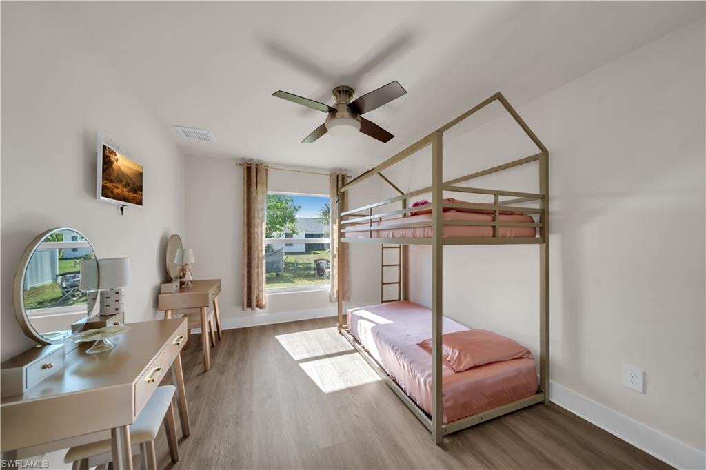 Bedroom with wood finished floors and ceiling fan