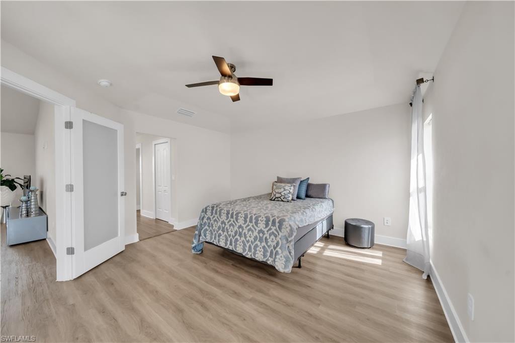 Bedroom with light wood-style floors and ceiling fan