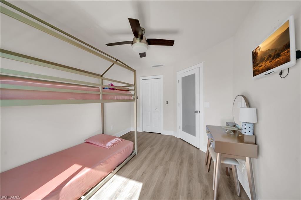 Unfurnished bedroom featuring light wood-style floors and a ceiling fan