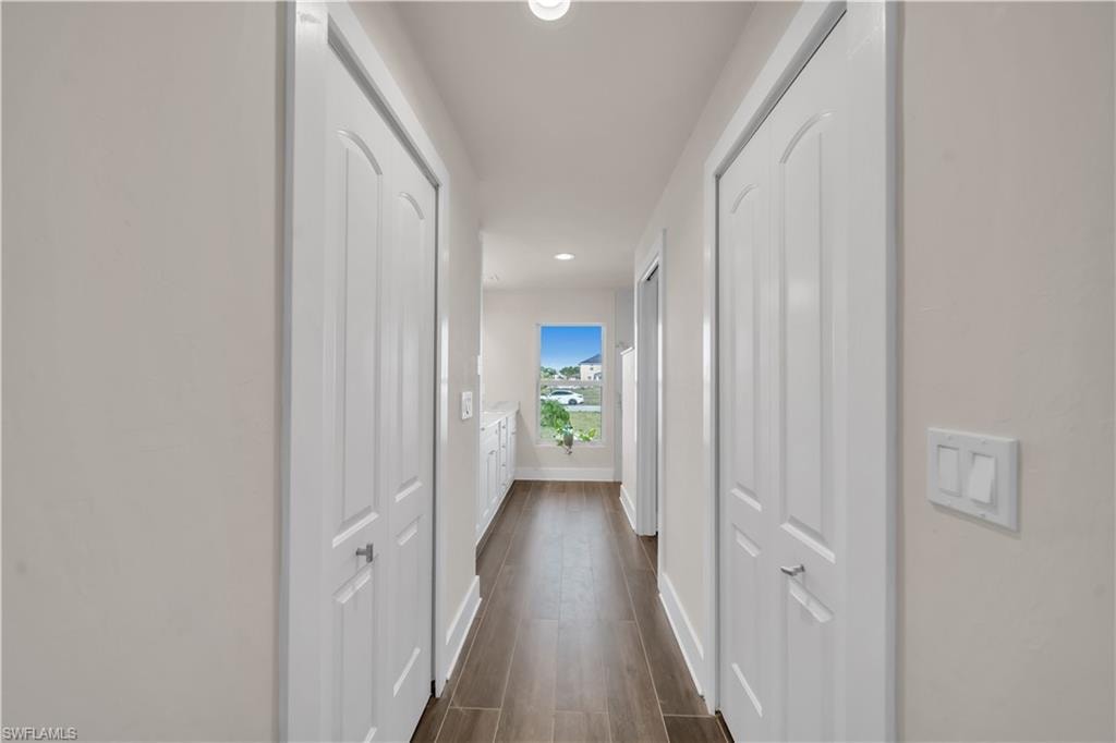 Corridor featuring recessed lighting and dark wood-style floors