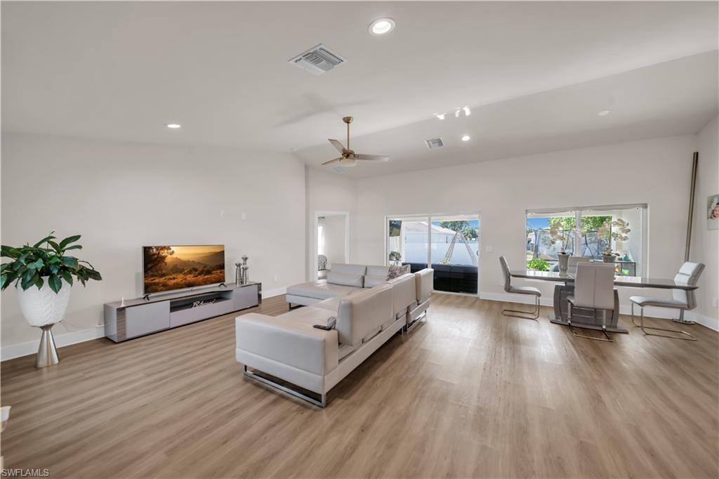Living area featuring light wood-style floors, recessed lighting, and ceiling fan