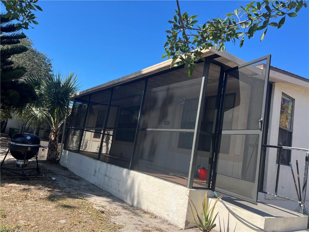 View of side of home featuring a sunroom
