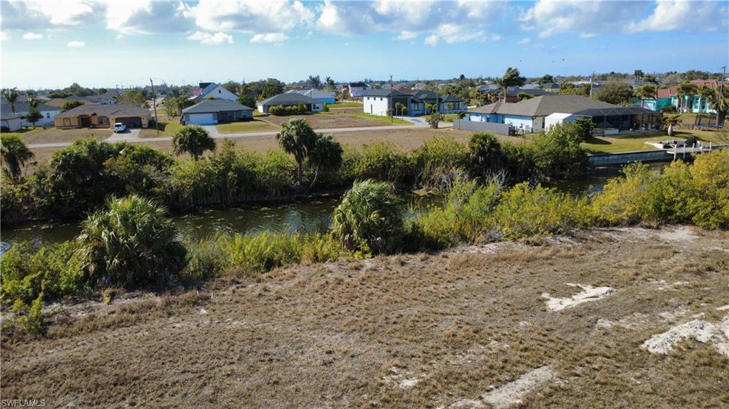 View of yard with a residential view and a water view